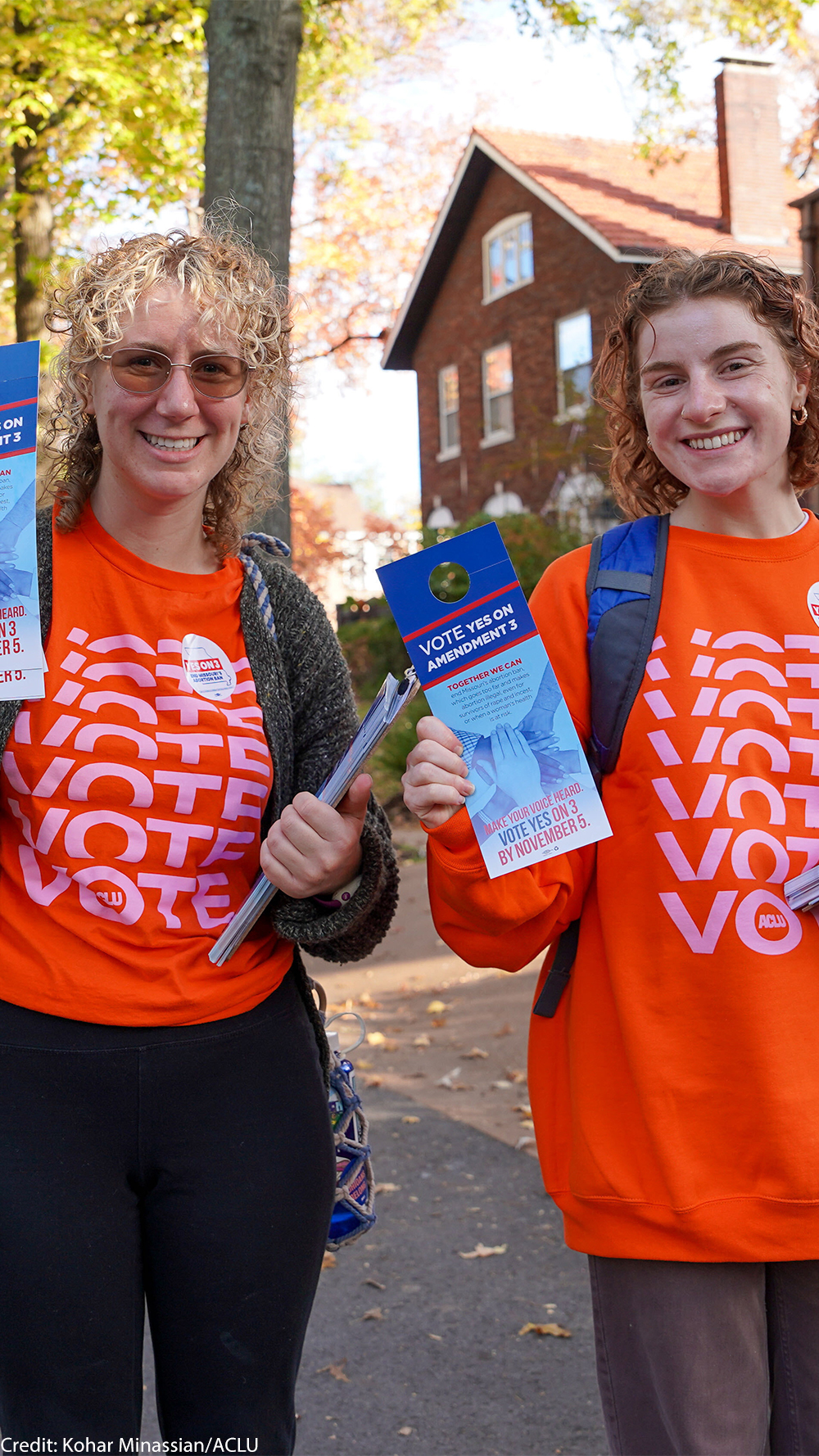 Voter volunteers holding voting pamphlets.