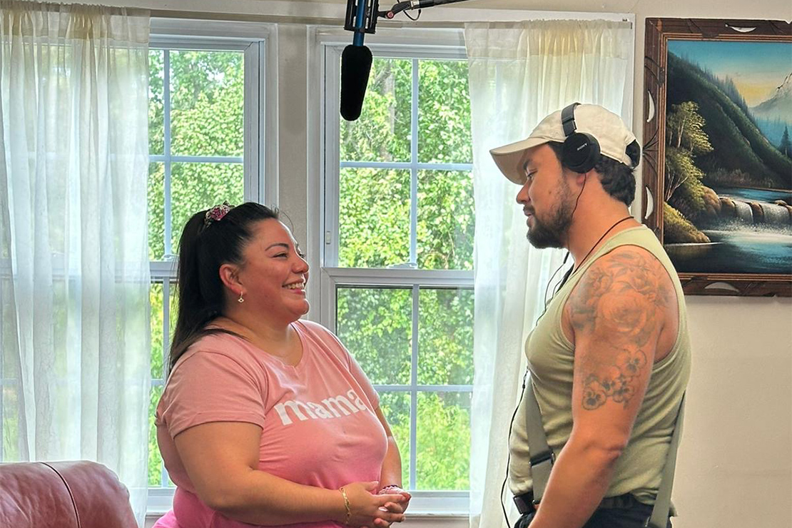 Two crew members discuss a shot behind the scenes for "The Long Road Home" article.