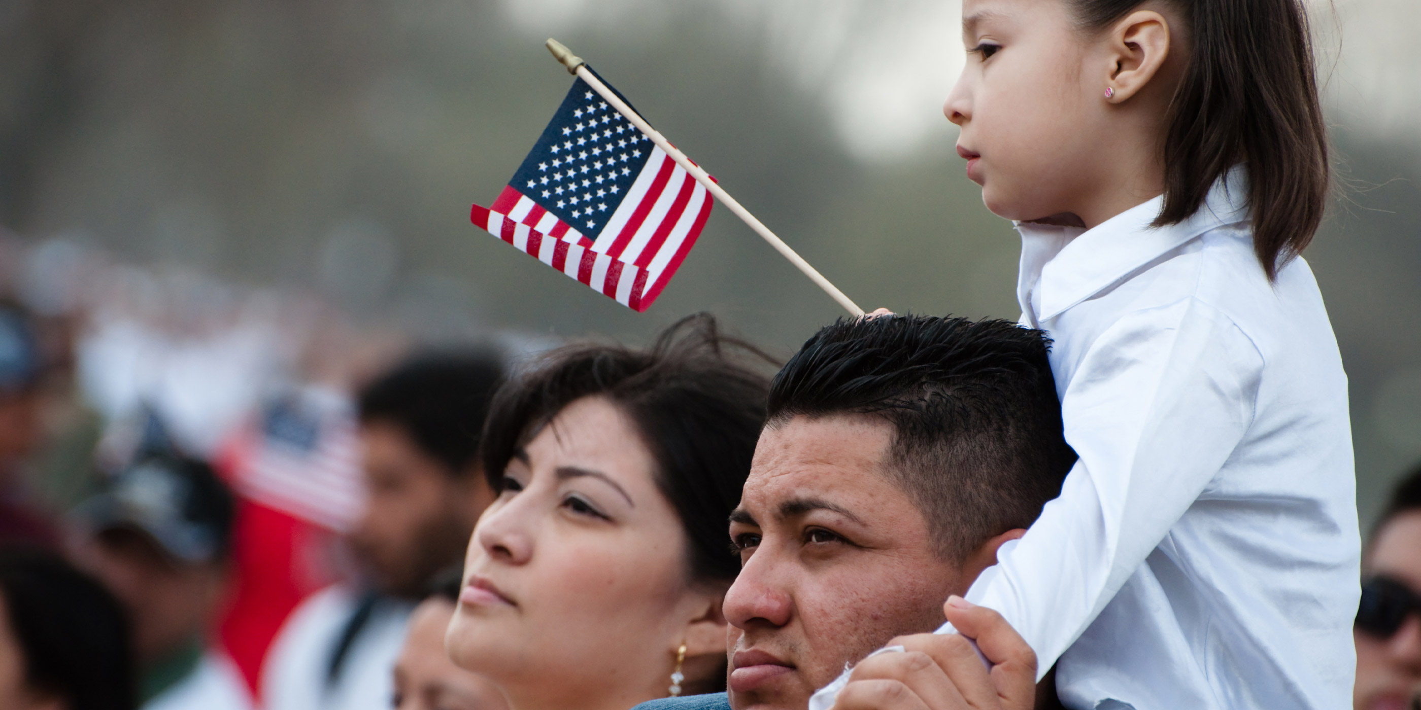 A girl and her father stand with some 200,000 immigrants' rights activists flood the National Mall to demand comprehensive immigration reform in Washington DC.