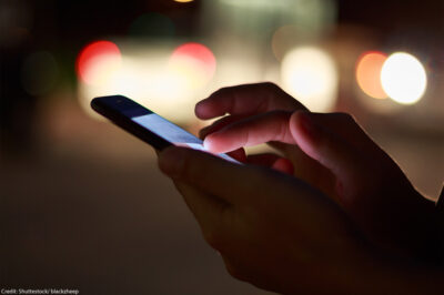 A photo of a someone scrolling on a smartphone.