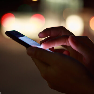 A photo of a someone scrolling on a smartphone.