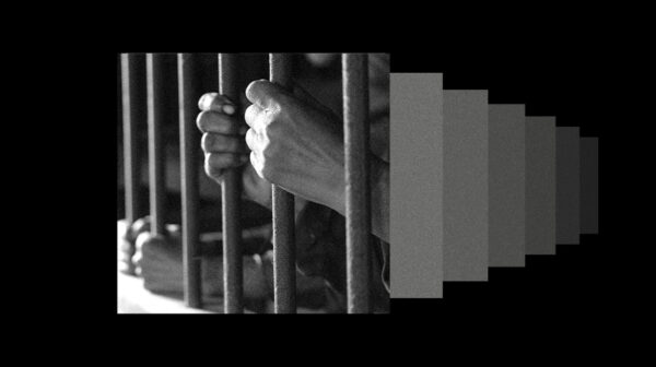 A graphic depicting an individual's hands holding prison bars.