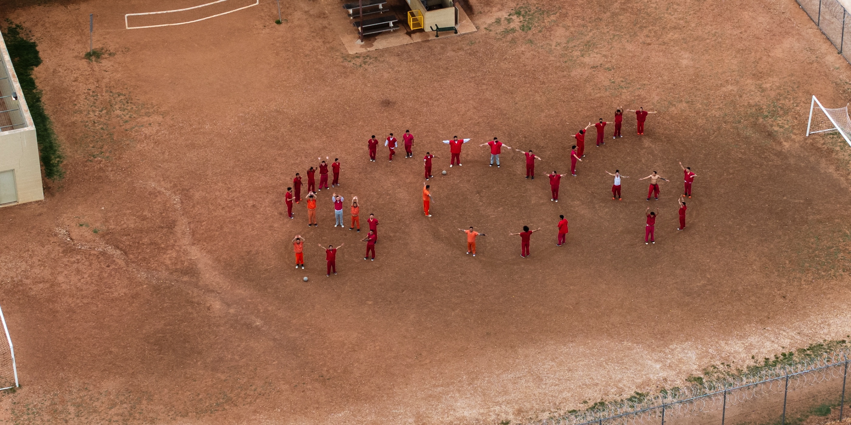 A drone view of detainees forming the letters SOS with their bodies in the courtyard at the Bluebonnet Detention Facility, where Venezuelans who the Trump administration is attempting to deport under the Alien Enemies Act are being held. Credit: REUTERS/Paul Ratje