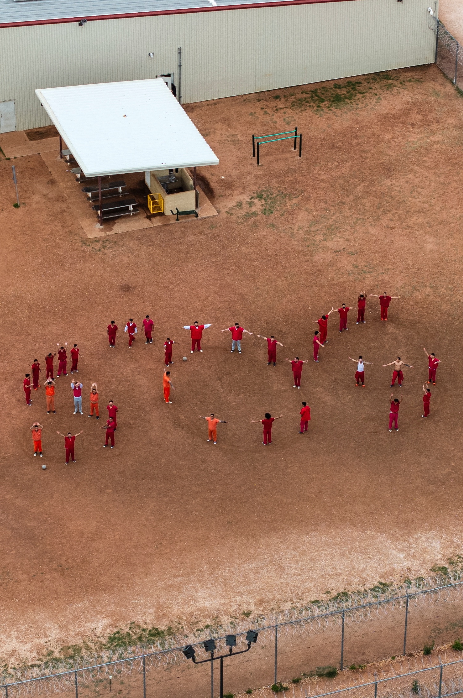 A drone view of detainees forming the letters SOS with their bodies in the courtyard at the Bluebonnet Detention Facility, where Venezuelans who the Trump administration is attempting to deport under the Alien Enemies Act are being held. Credit: REUTERS/Paul Ratje