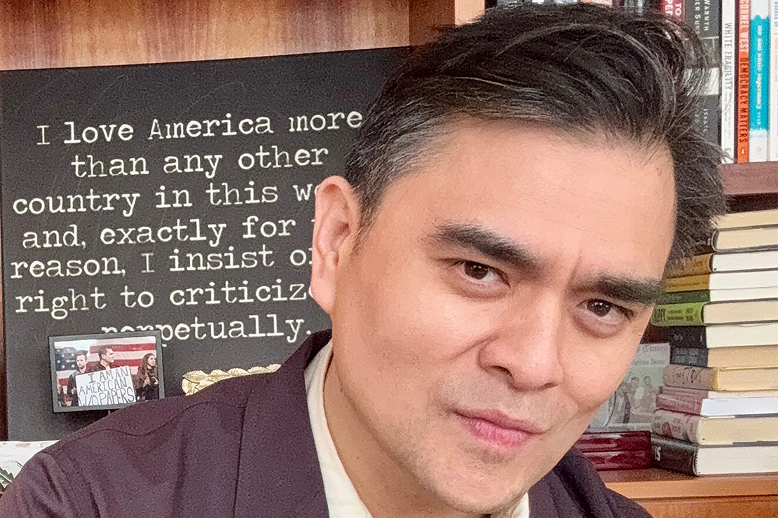 A headshot of Jose Antonio Vargas with a blackboard in the background which displays the message "I love America more than any other country in this world and, exactly for this reason, I insist on the right to criticize it perpetually."