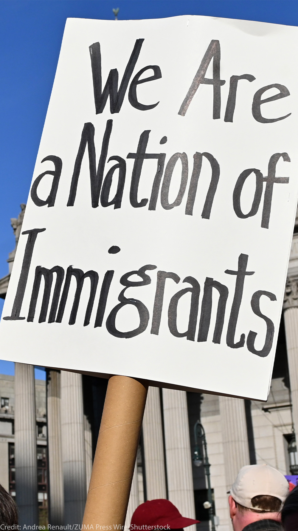 Two signs are held up during the May Day March In Manhattan, New York on May 1, 2025. The largest of the signs is in the foreground and reads"We Are a Nation of Immigrants," while the smaller in the background reads, " WE ARE ALL (EXCEPT NATIVE AMERICANS) IMMIGRANTS! PUT I.C.E. ON ICE NOW".