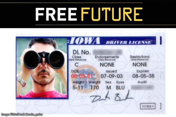 A driver's license in which the photo shows a man peering at the camera through binoculars