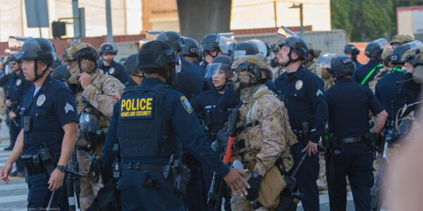 Border Patrol agents and police congregating during during a demonstration against expanded ICE operations and in support of immigrant rights.