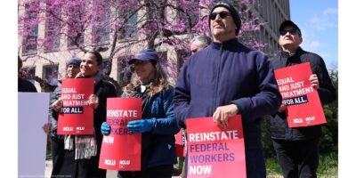 Demonstrators hold signs from Ƶ & Ƶ DC that read" REINSTATE FEDERAL WORKERS NOW" and "EQUAL AND JUST TREATMENT FOR ALL" as they protest in support of Federal Workers at the Office of Personnel Management in Washington, DC.