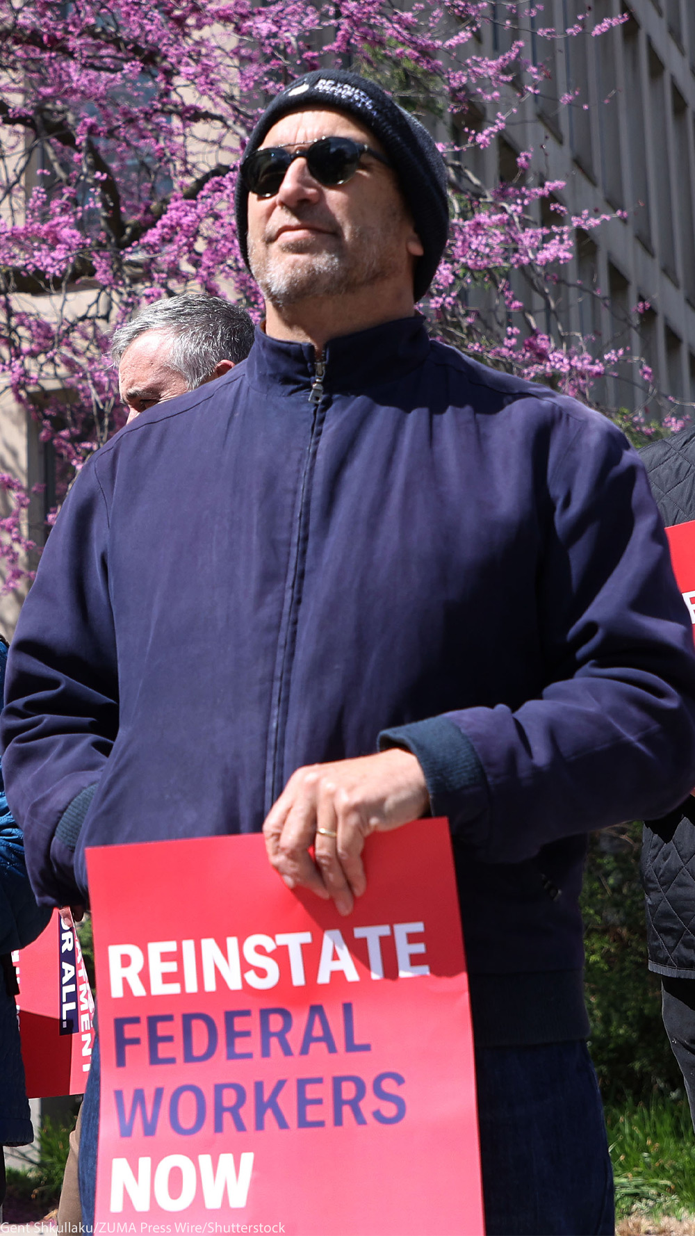 Demonstrators hold signs from Ƶ & Ƶ DC that read" REINSTATE FEDERAL WORKERS NOW" and "EQUAL AND JUST TREATMENT FOR ALL" as they protest in support of Federal Workers at the Office of Personnel Management in Washington, DC.