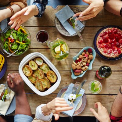 A group of people have an animated conversation over a dinner table.