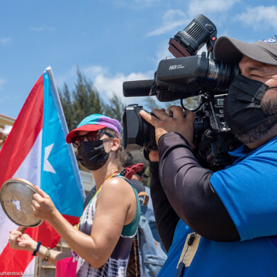 A individual filming a protest in Rincon, Puerto Rico.