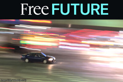 A sole car driving at night amid bright blurry lights
