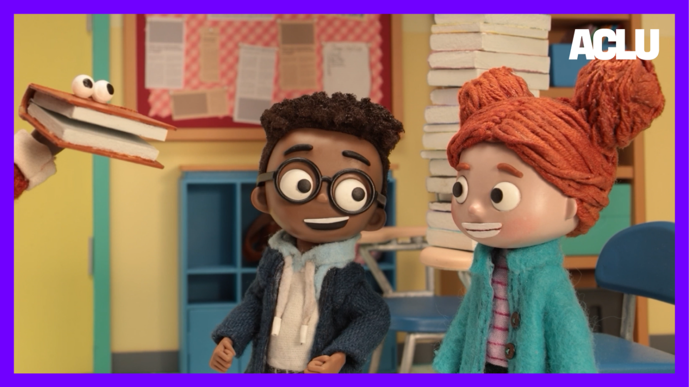 A still frame from episode 2: Aaron and Lisa receive advice from a talking book.