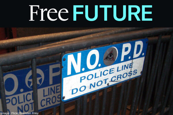 A sign on a metal rack reading "N.O.P.D. / police line / do not cross"