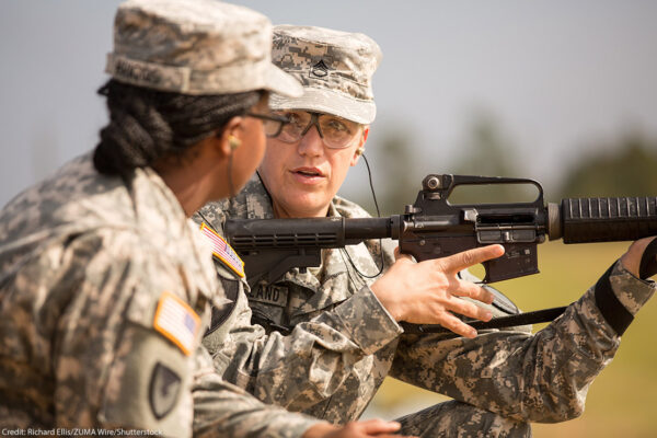 A woman Drill Sergeant candidate given instruction by a women Drill Sergeant instructor.