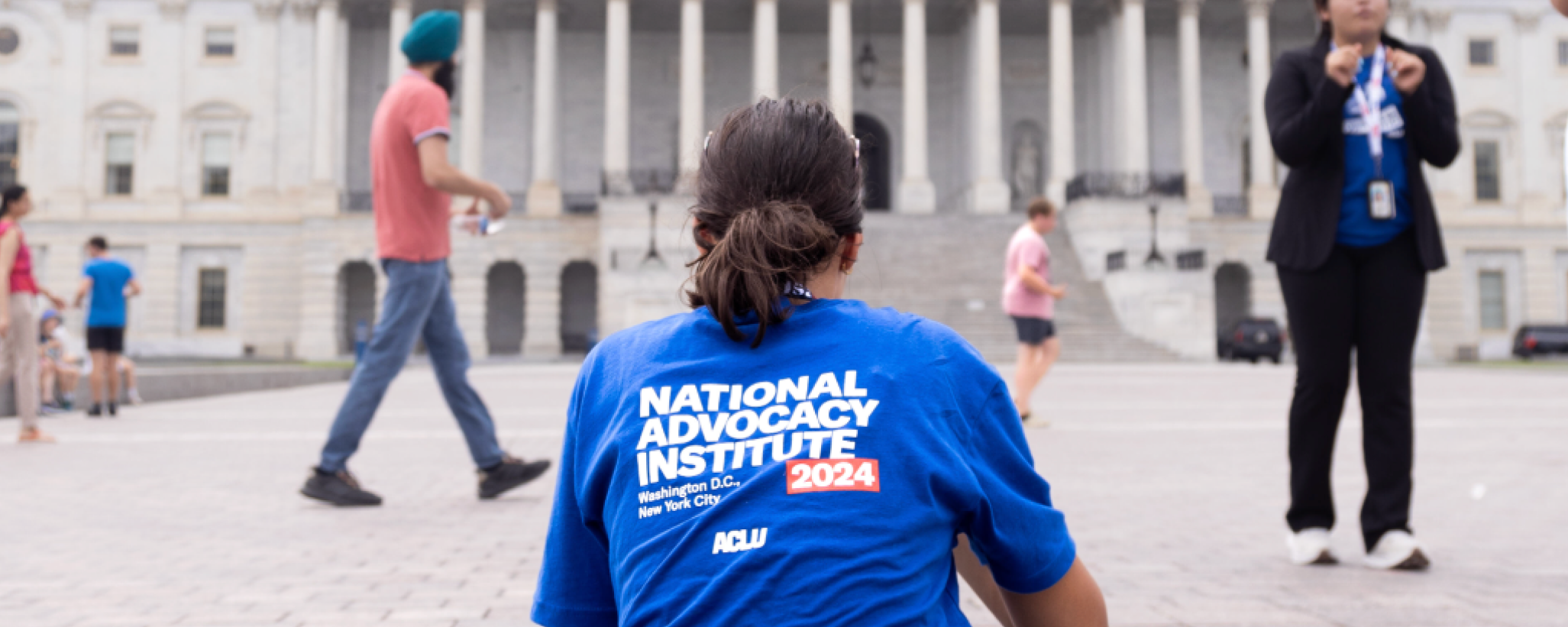 An individual wearing a National Advocacy Institute t shirt.