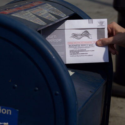A mail in ballot placed in mail box.