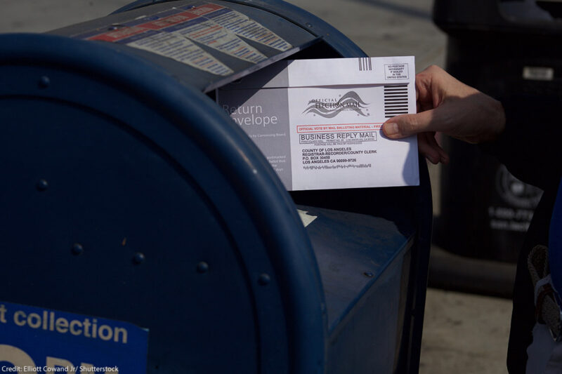 A mail in ballot placed in mail box.