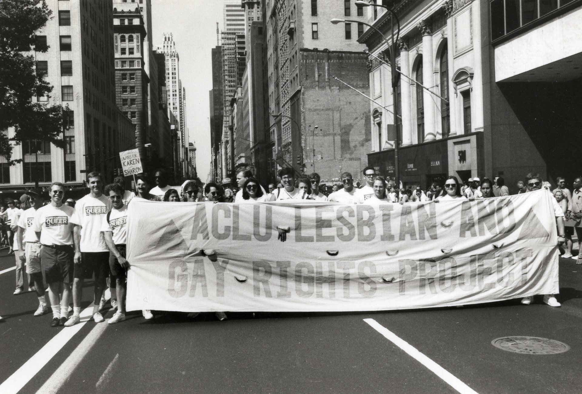 Demonstrators march while carrying an "ACLU LESBIAN AND GAY RIGHTS PROJECT" banner