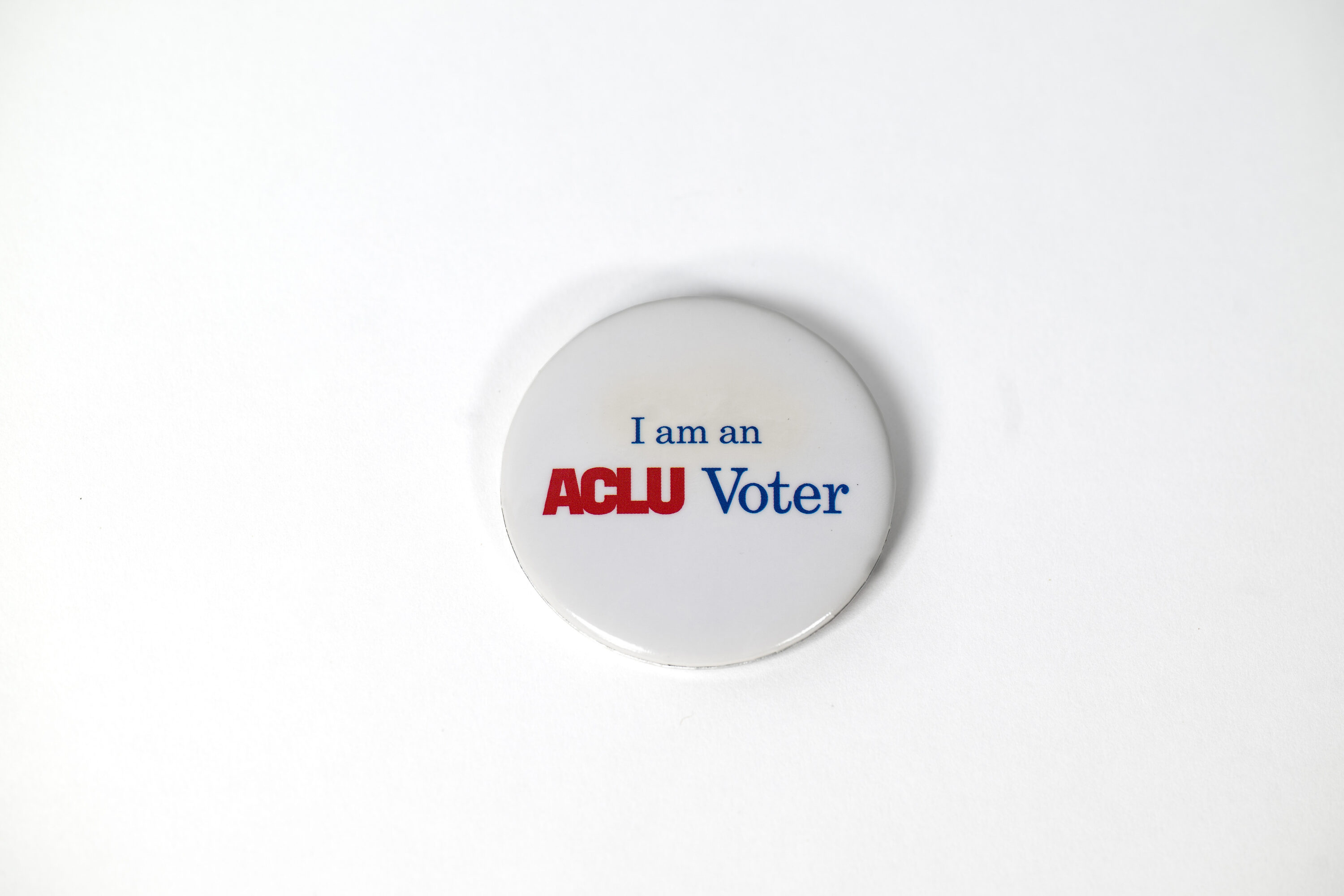 Small pin reads "I am an ACLU Voter"