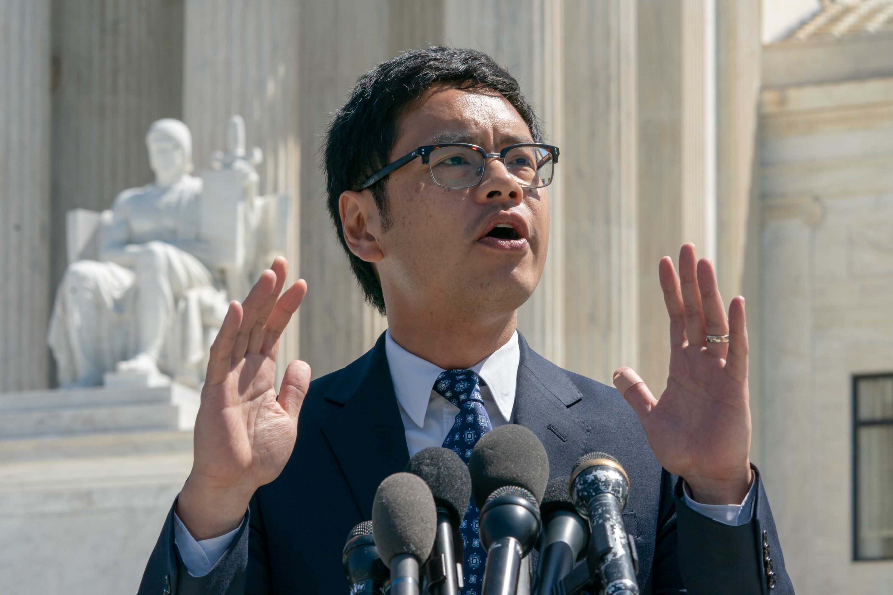 Dale Ho speaks to reporters in front of the Supreme Court