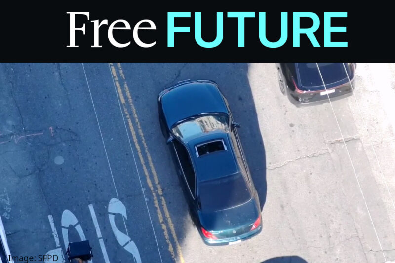 Aerial drone photo of a car with sunroof driving down street