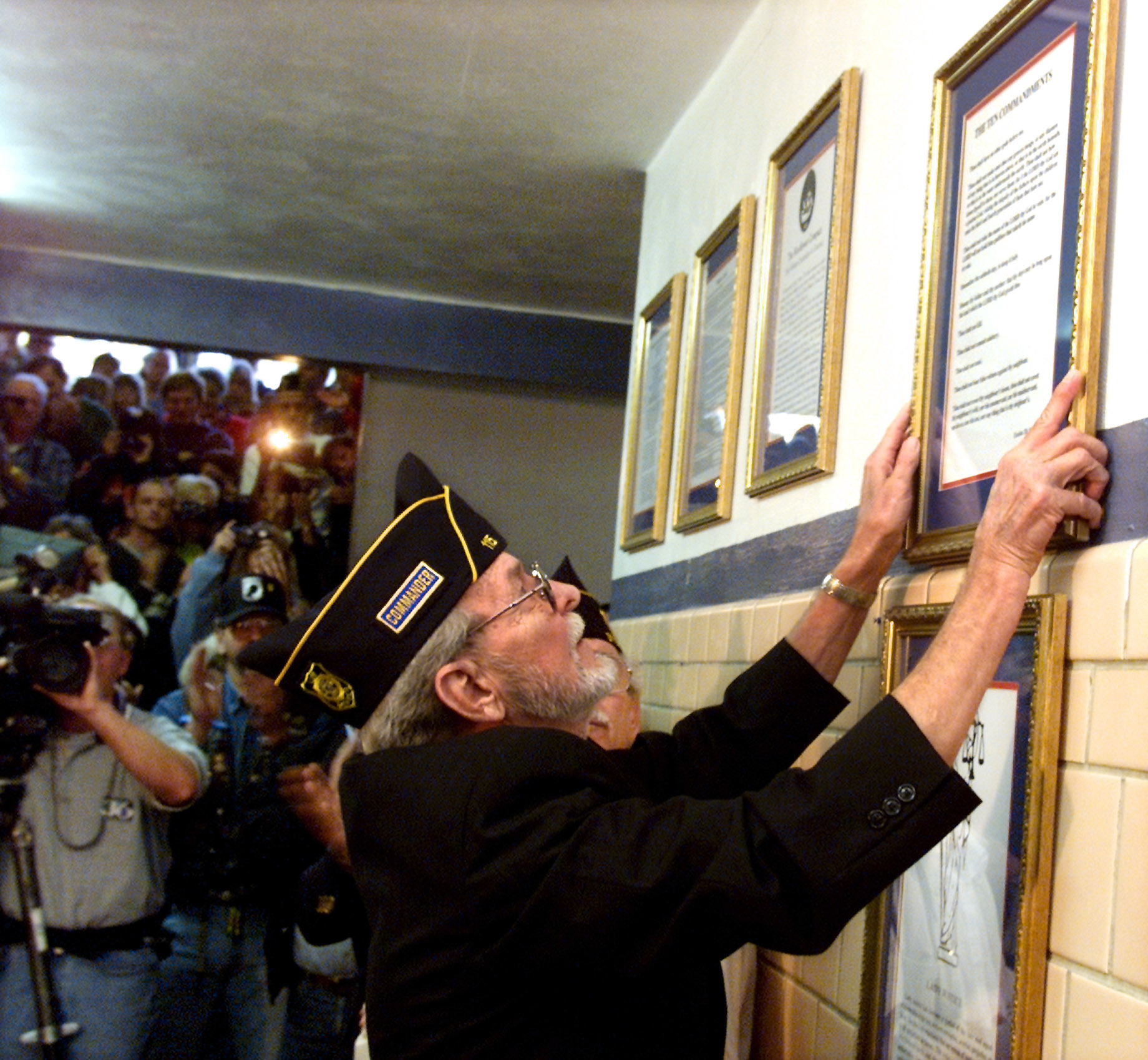 Paul Worthington hangs a copy of the Ten Commandments the McCreary County courthouse in Whitley City, Kentucky