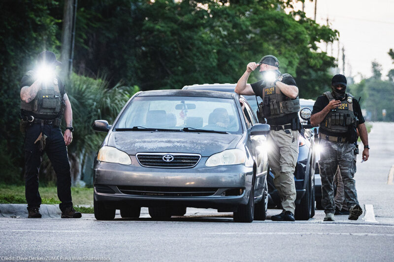 ICE agents temporarily halting a driver.