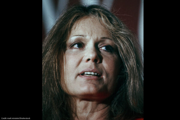 A headshot of Gloria Steinem on a black background.