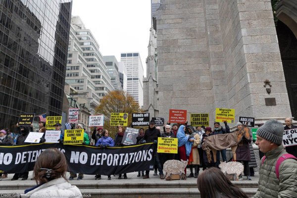 Anti-ICE demonstrators holding signs that say "NO DETENTIONS NO DEPORTATIONS' and 'FIRST THEY CAME FOR THE IMMIGRANTS."