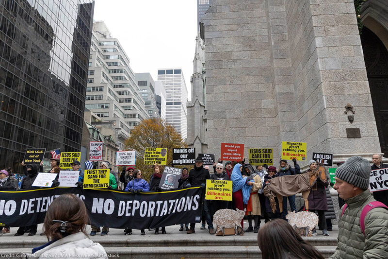 Anti-ICE demonstrators holding signs that say "NO DETENTIONS NO DEPORTATIONS' and 'FIRST THEY CAME FOR THE IMMIGRANTS."