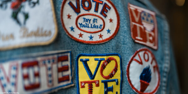 A group of patches on denim encouraging people to vote.