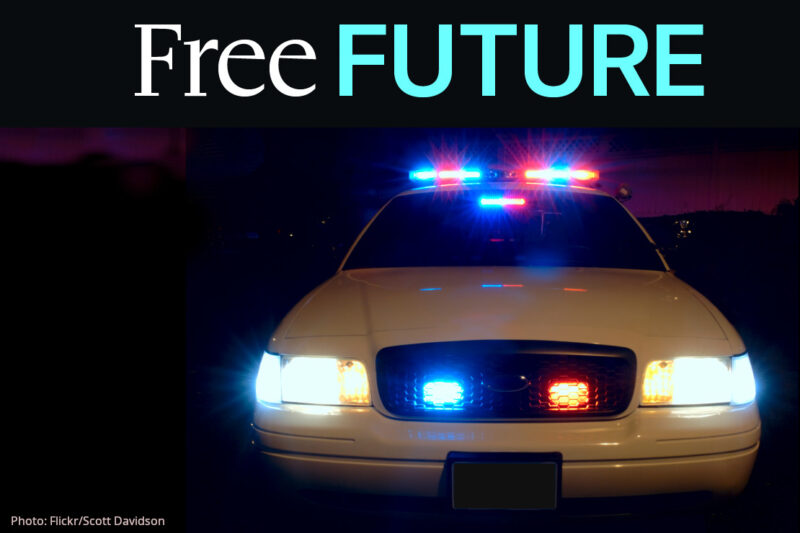 A frontal image of a police car with its lights on