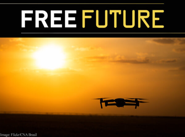 Silhouette of a drone in the sky against a setting sun