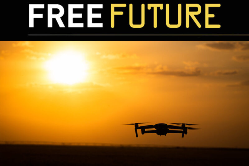 Silhouette of a drone in the sky against a setting sun