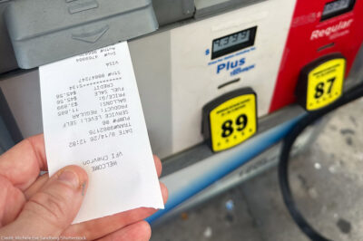 A customer pumps gasoline at a gas station in South Florida as fuel prices remain elevated.