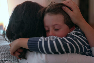 Mother comforting crying child.