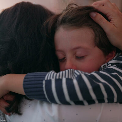 Mother comforting crying child.