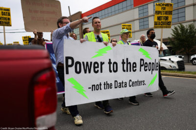 People gather near the site of a proposed data center to protest its development in Alexandria, Virginia.