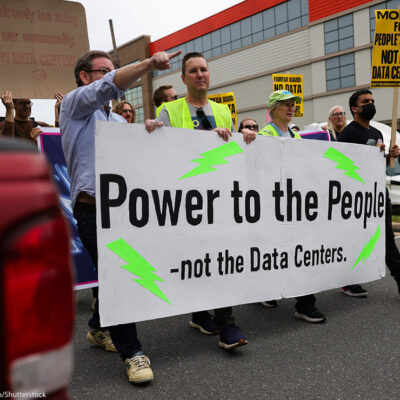 People gather near the site of a proposed data center to protest its development in Alexandria, Virginia.