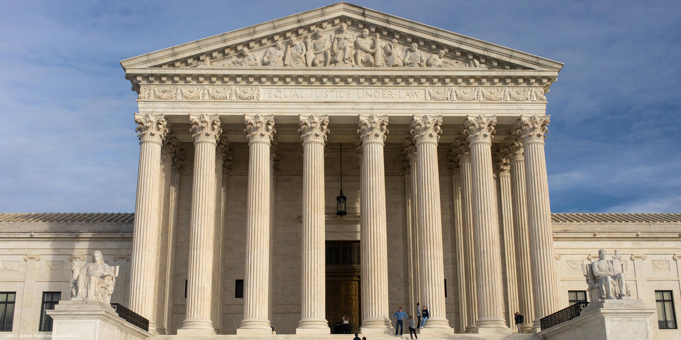 The facade of the Supreme Court of the United States building against a blue sky,