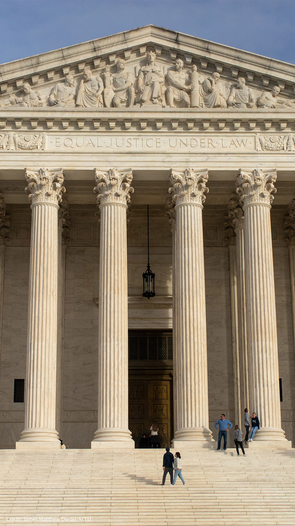 The facade of the Supreme Court of the United States building against a blue sky,