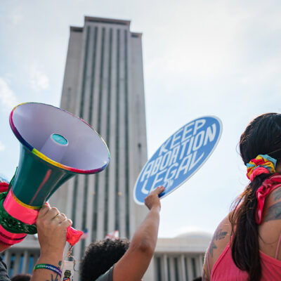 A demonstrator holding a sign saying "Keep Abortion Legal."